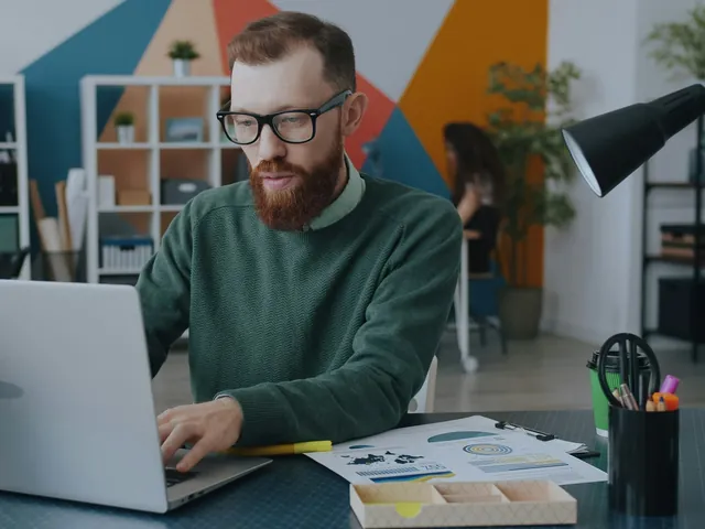 A founder working at a laptop in a studio office