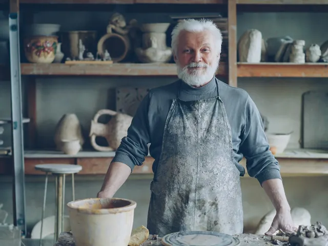 A potter standing at the bench in his workshop